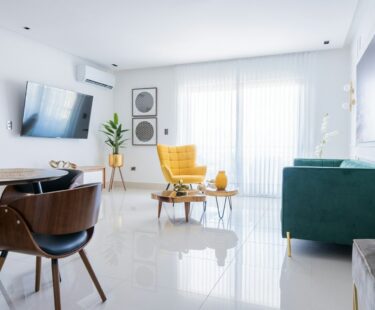 a living room filled with furniture and a flat screen tv